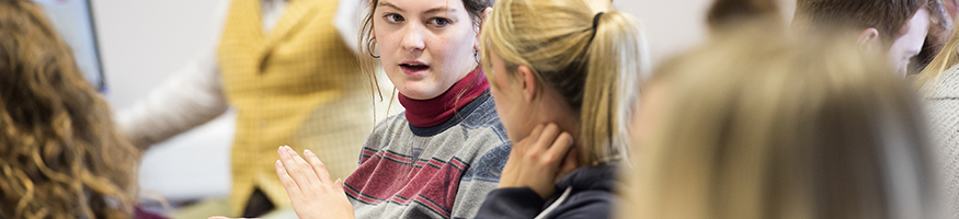 Students in classroom,two students visibly having a discussion